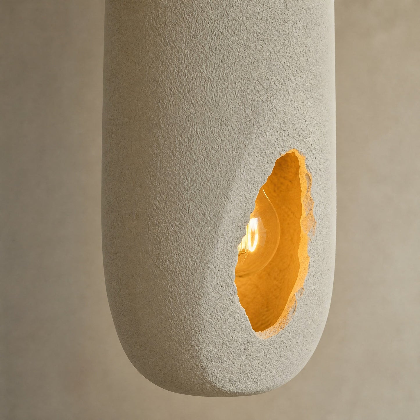 Detail of the sandy texture and amber opening on the Korven pendant light | Wickleigh