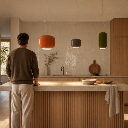 Trio of Ulvin coloured glass pendant lights, amber, moka and olive green, above a kitchen island | Wickleigh