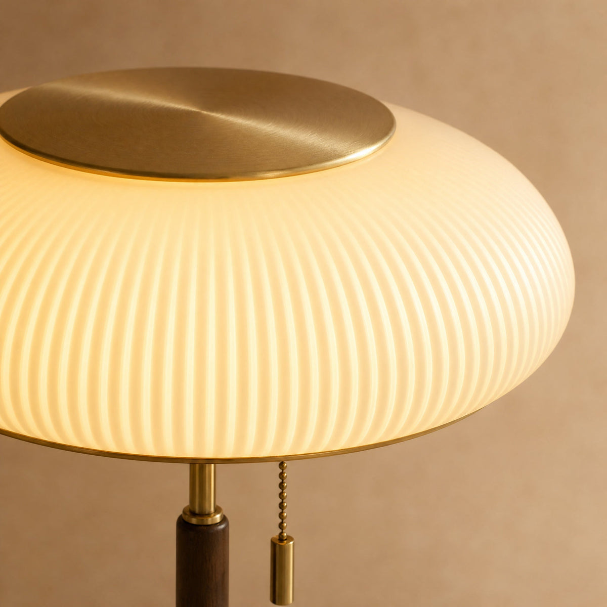 Detail of the lit ribbed opaline glass and brushed gold disc on the Grelin lamp | Wickleigh